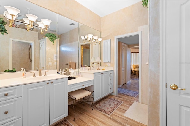 bathroom featuring vanity, hardwood / wood-style floors, and a chandelier