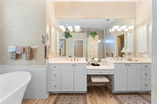 bathroom with vanity, a bathtub, and hardwood / wood-style flooring