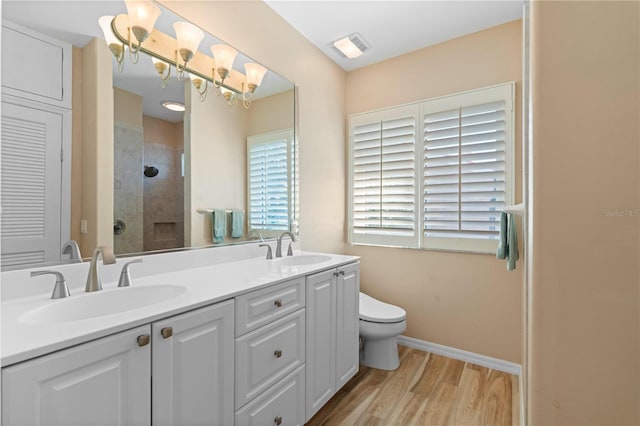 bathroom with vanity, hardwood / wood-style flooring, toilet, and an enclosed shower