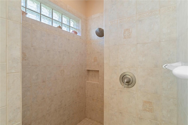 bathroom with tiled shower