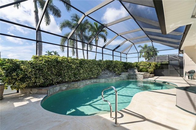 view of pool featuring pool water feature, a patio area, and a lanai