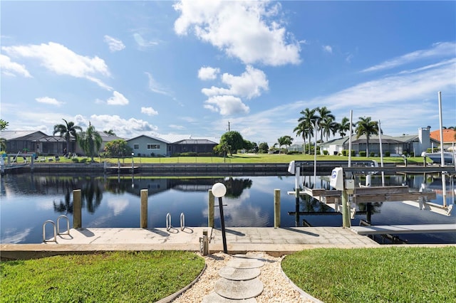 dock area with a yard and a water view