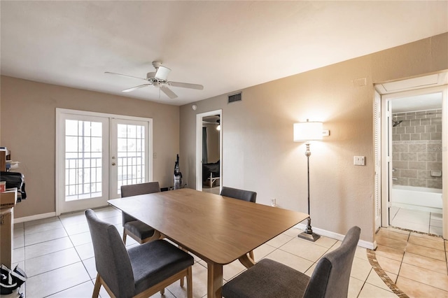 dining area with french doors, light tile patterned floors, and ceiling fan