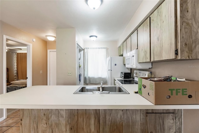 kitchen featuring light tile patterned floors, sink, kitchen peninsula, and electric range oven