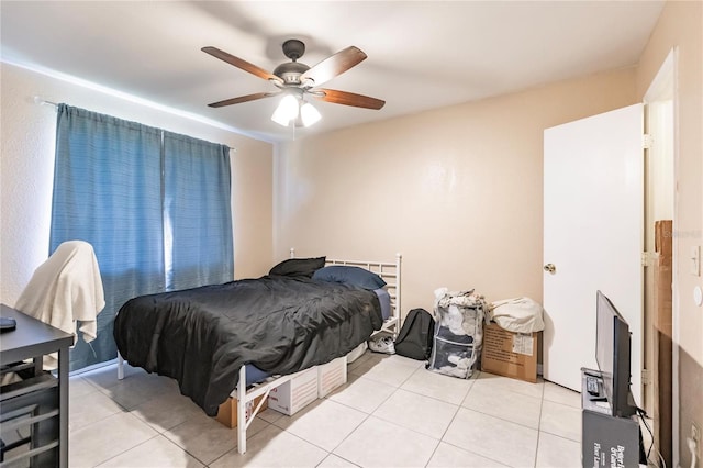 bedroom with ceiling fan and light tile patterned floors