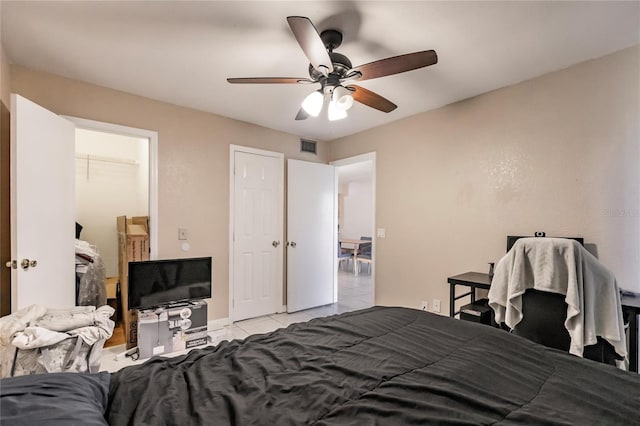 tiled bedroom with ceiling fan