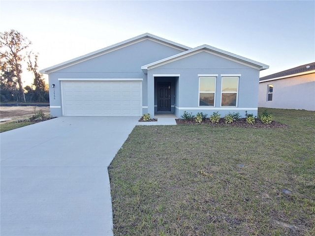 ranch-style house with a yard and a garage