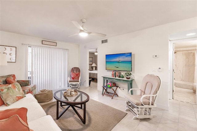 living room with light tile patterned floors and ceiling fan