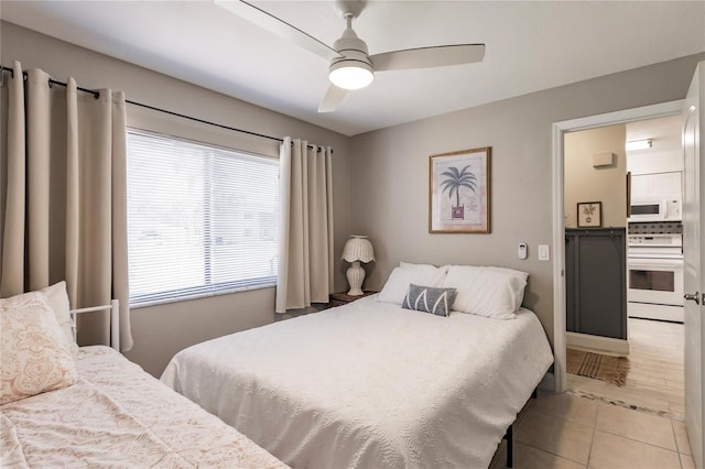 tiled bedroom featuring ceiling fan