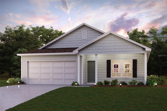 view of front of home with a garage and a lawn