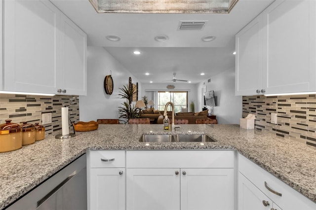 kitchen featuring white cabinets and sink