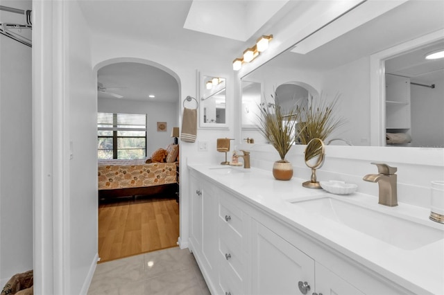 bathroom featuring wood-type flooring, vanity, and ceiling fan