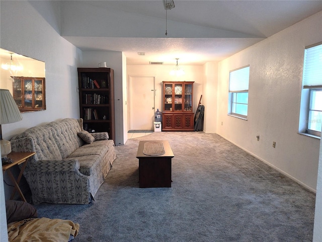 living room featuring carpet, vaulted ceiling, and a chandelier