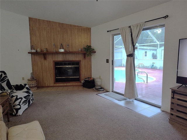 living room featuring wooden walls, vaulted ceiling, and light carpet