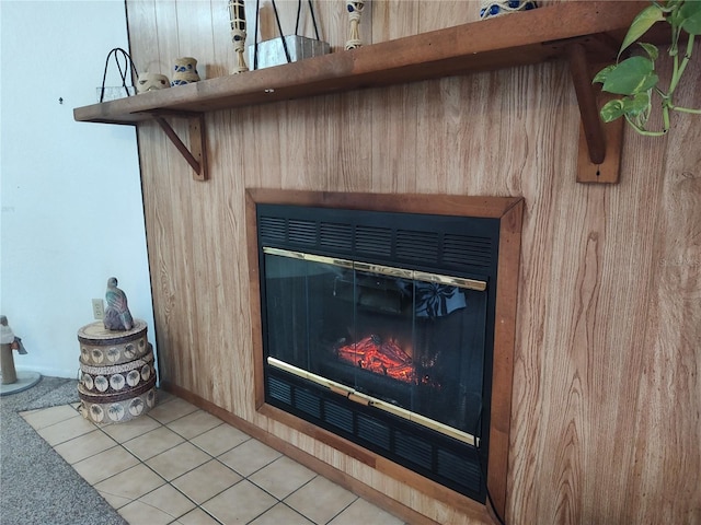 interior details with wood walls and tile patterned flooring