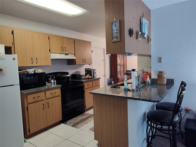 kitchen featuring black appliances, sink, kitchen peninsula, dark stone counters, and light tile patterned floors