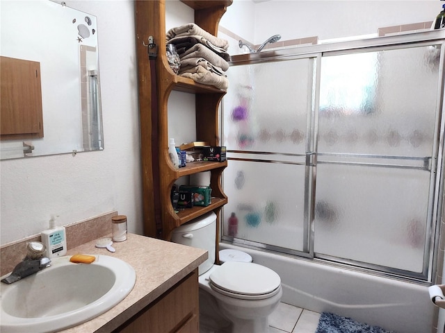 full bathroom with vanity, enclosed tub / shower combo, toilet, and tile patterned floors