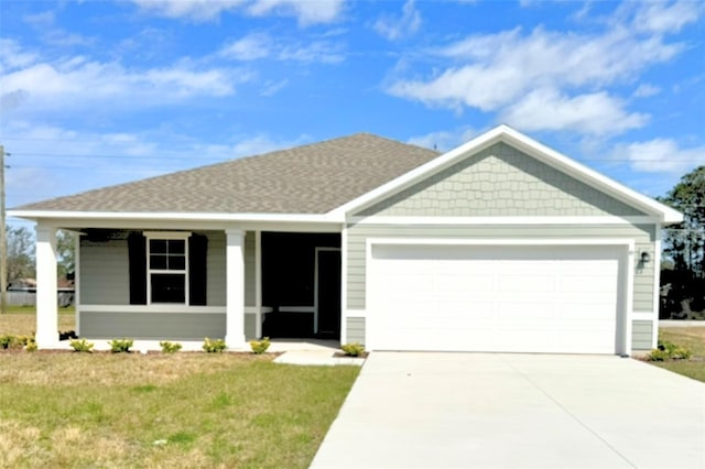 view of front of house featuring roof with shingles, a porch, an attached garage, driveway, and a front lawn