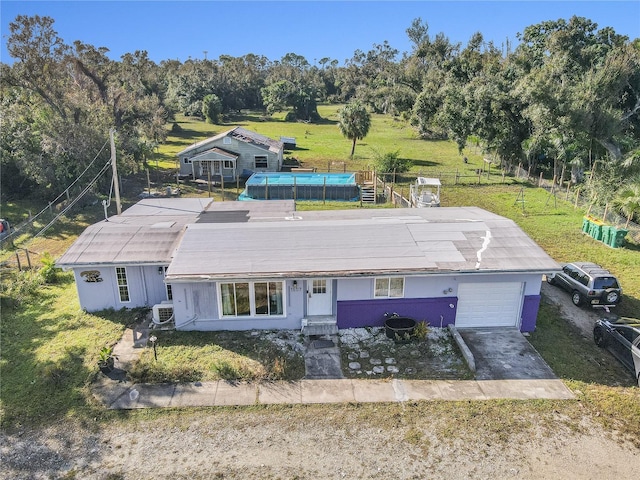 1507 Lavilla Rd, Punta Gorda, FL 33950 - view of front facade featuring a pool, stucco siding, driveway, a front yard, and a garage