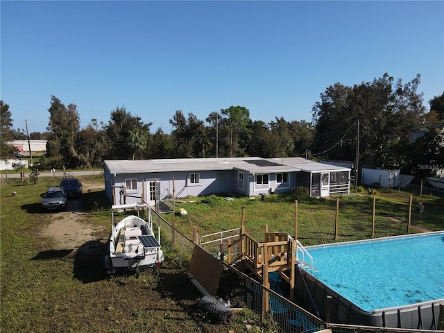1507 Lavilla Rd, Punta Gorda, FL 33950 - back of house with a lawn, fence, and a fenced in pool