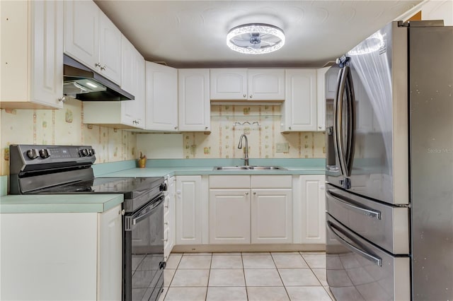 kitchen with white cabinetry, sink, stainless steel fridge, and black / electric stove