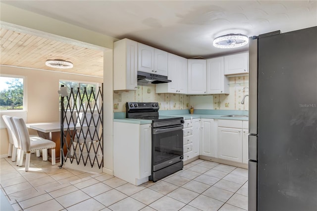 kitchen with white cabinetry, sink, light tile patterned flooring, and appliances with stainless steel finishes