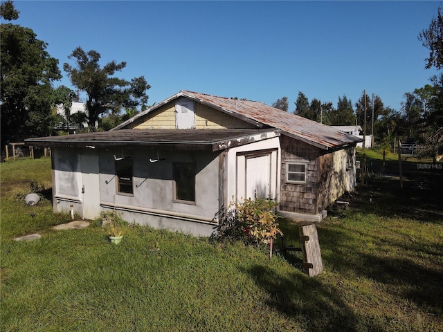 view of home's exterior with a lawn