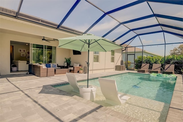 view of swimming pool with outdoor lounge area, glass enclosure, ceiling fan, and a patio area