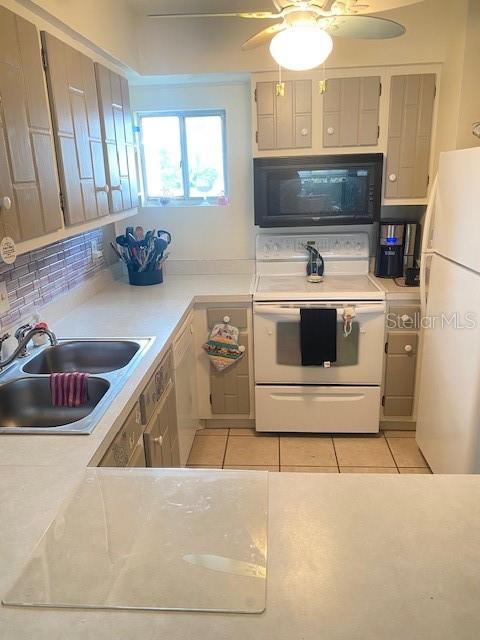 kitchen with ceiling fan, white appliances, sink, decorative backsplash, and light tile patterned floors