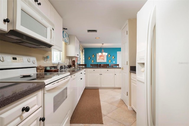 kitchen featuring white cabinetry, light tile patterned floors, pendant lighting, an inviting chandelier, and white appliances