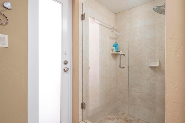 bathroom with a shower with shower door