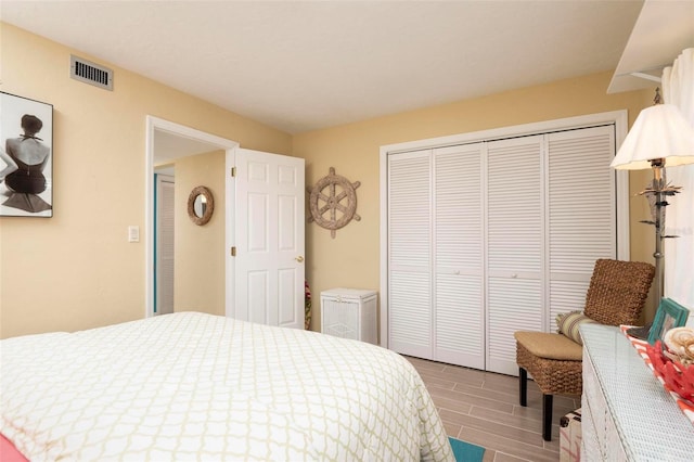 bedroom with hardwood / wood-style floors and a closet