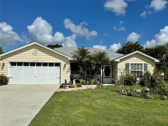 ranch-style home featuring a garage, a porch, and a front lawn