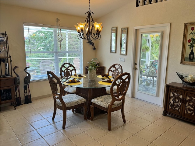 tiled dining area with lofted ceiling and a chandelier