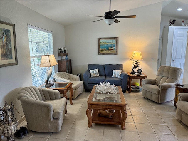 tiled living room featuring ceiling fan and vaulted ceiling