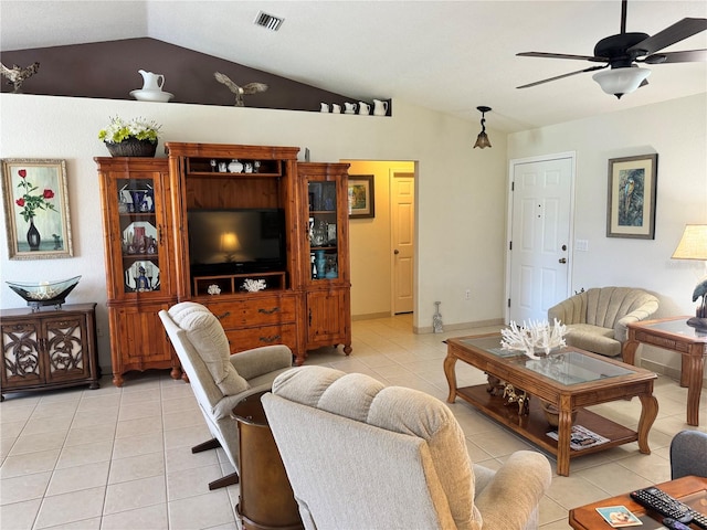 living room featuring ceiling fan, lofted ceiling, and light tile patterned floors