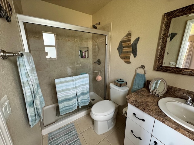 bathroom featuring an enclosed shower, tile patterned floors, vanity, and toilet