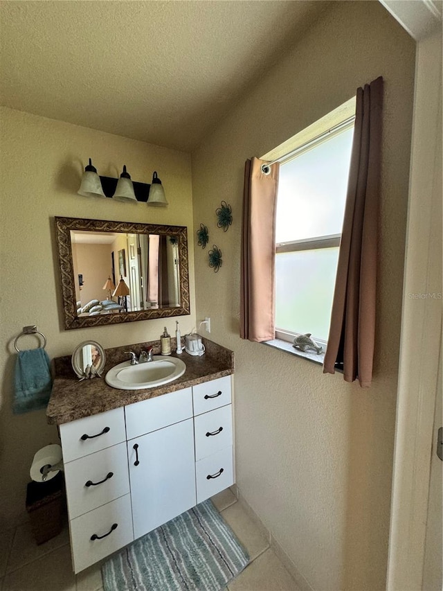 bathroom featuring vanity, a textured ceiling, and tile patterned floors