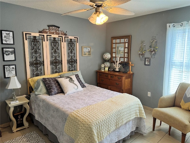 tiled bedroom with ceiling fan and a textured ceiling