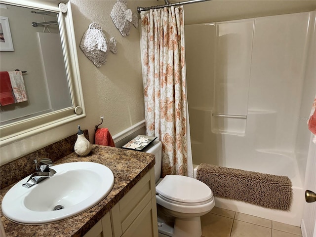 full bathroom with tile patterned floors, shower / tub combo, toilet, and vanity