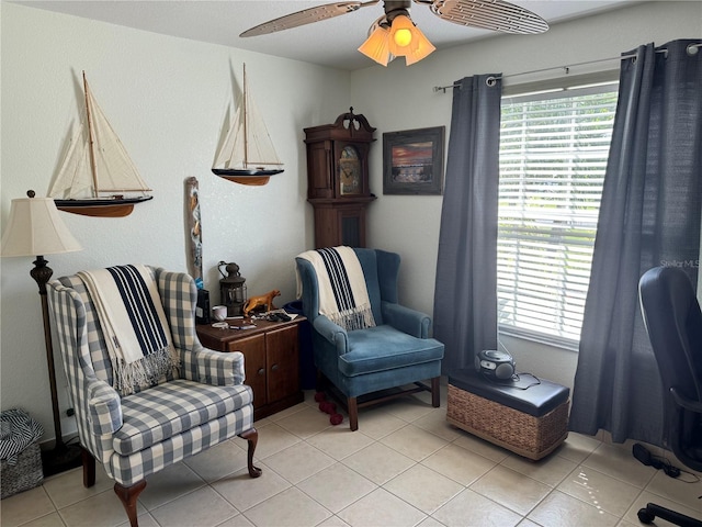 living area with ceiling fan and light tile patterned floors