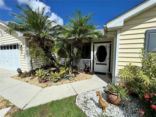 entrance to property featuring a garage and a porch