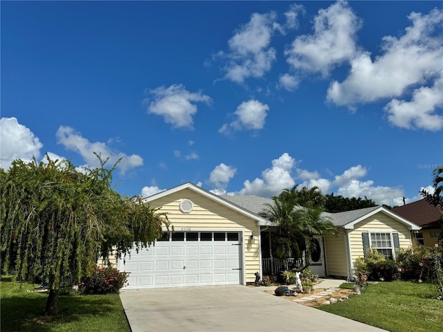 single story home with a front yard and a garage