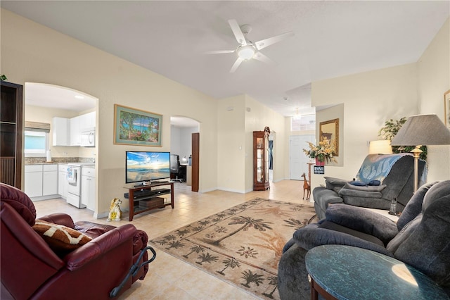 tiled living room with ceiling fan