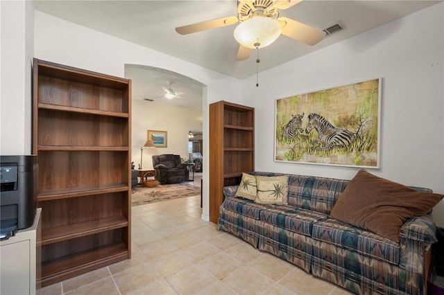 tiled living room featuring ceiling fan