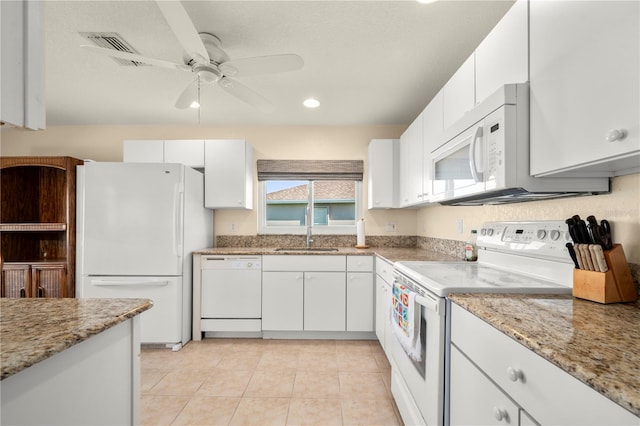 kitchen featuring white appliances, light stone countertops, sink, ceiling fan, and white cabinets