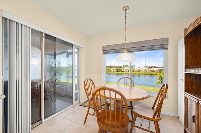 tiled dining space featuring a water view