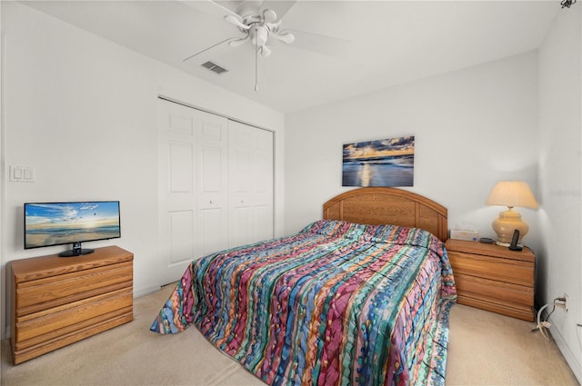 bedroom featuring light carpet, a closet, and ceiling fan