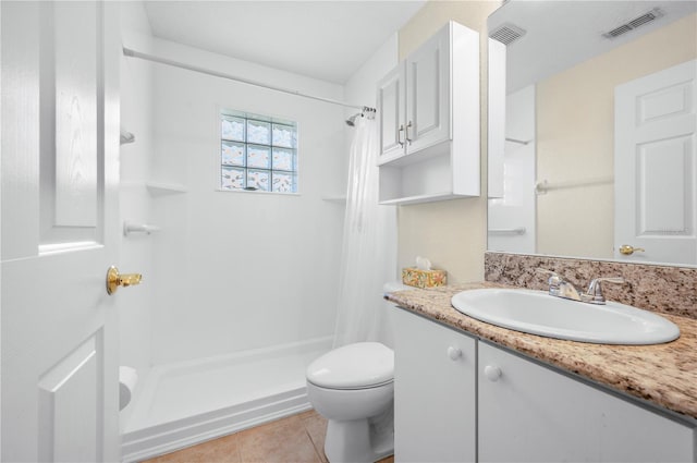 bathroom featuring vanity, toilet, tile patterned floors, and walk in shower