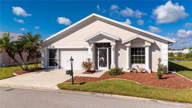 view of front of home with a front yard and a garage